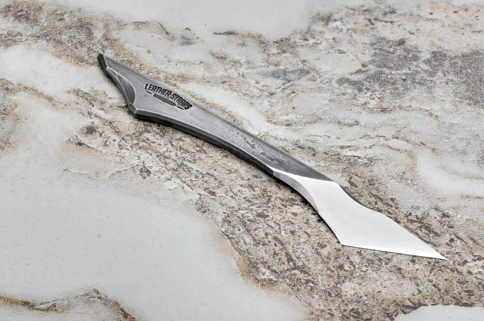 Fang Leather Knife, marble surface.