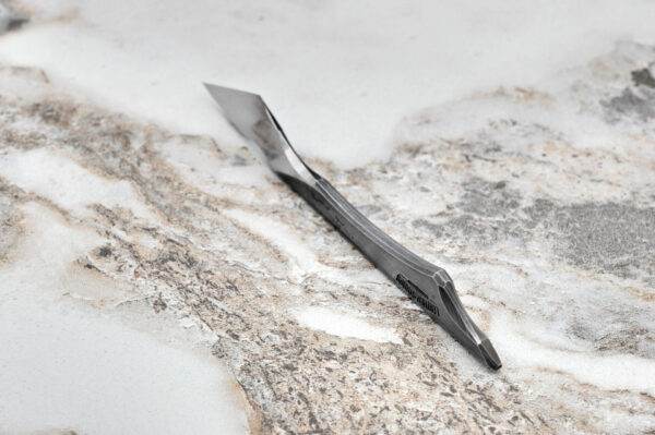 Fang Leather Knife, marble surface.