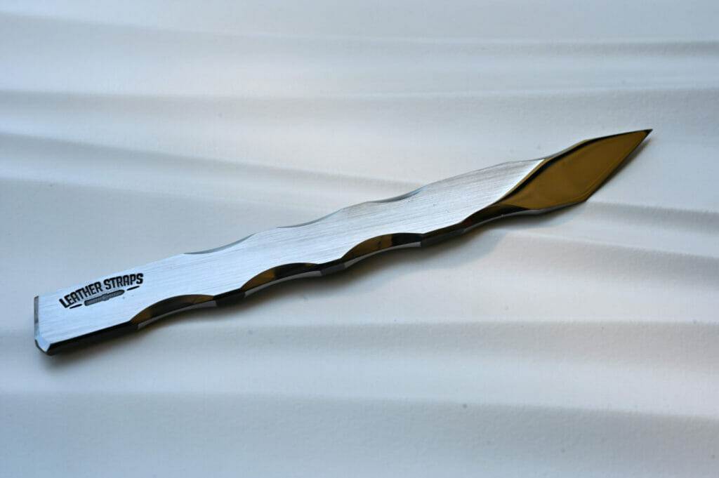 A silver scalpel resting on a white surface.