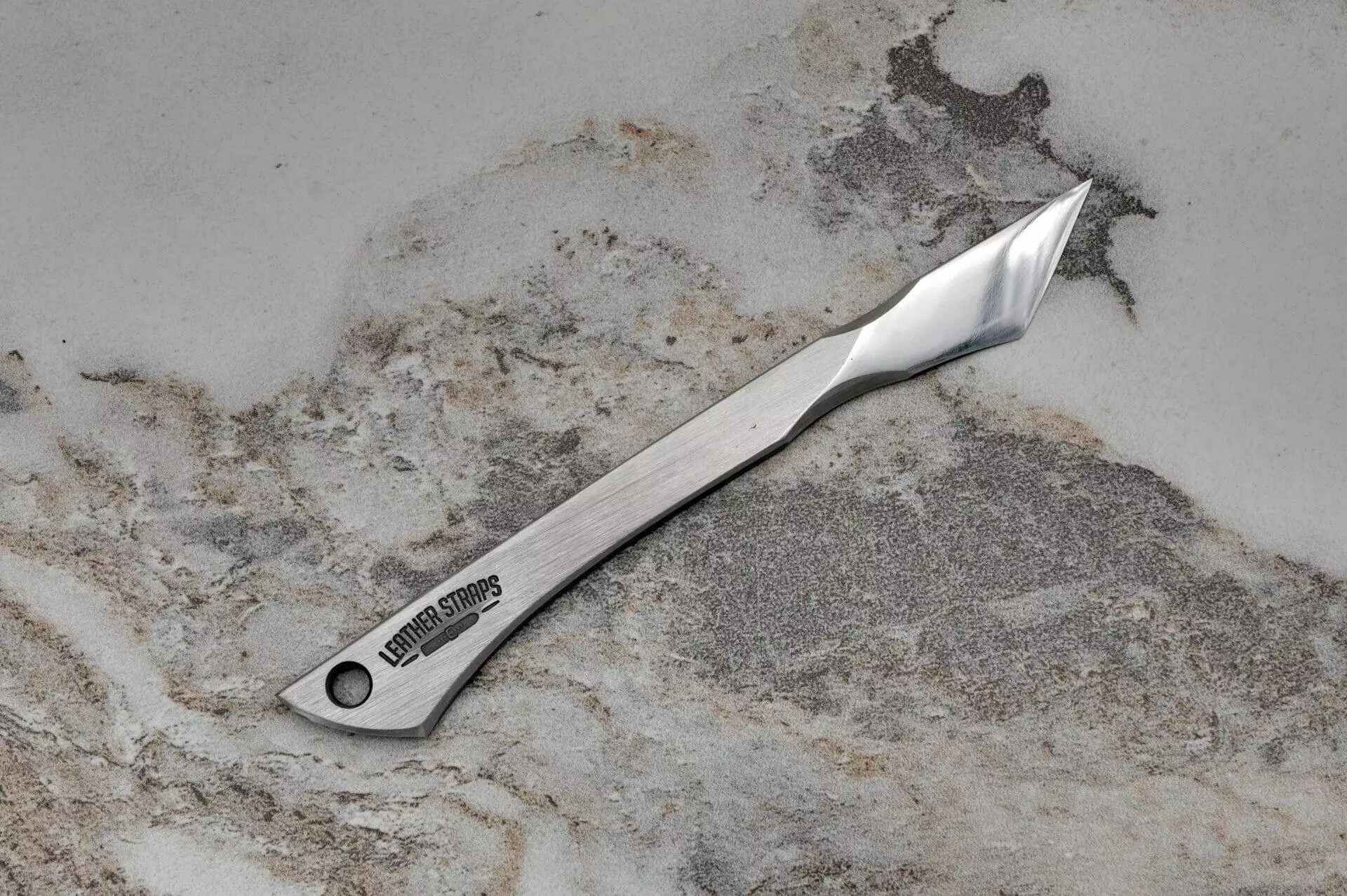 An Argo Leather Scalpel on a marble surface for precision cutting.