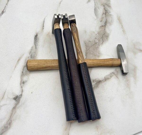 Three Carbide Tipped Straightening Hammers on a marble table.