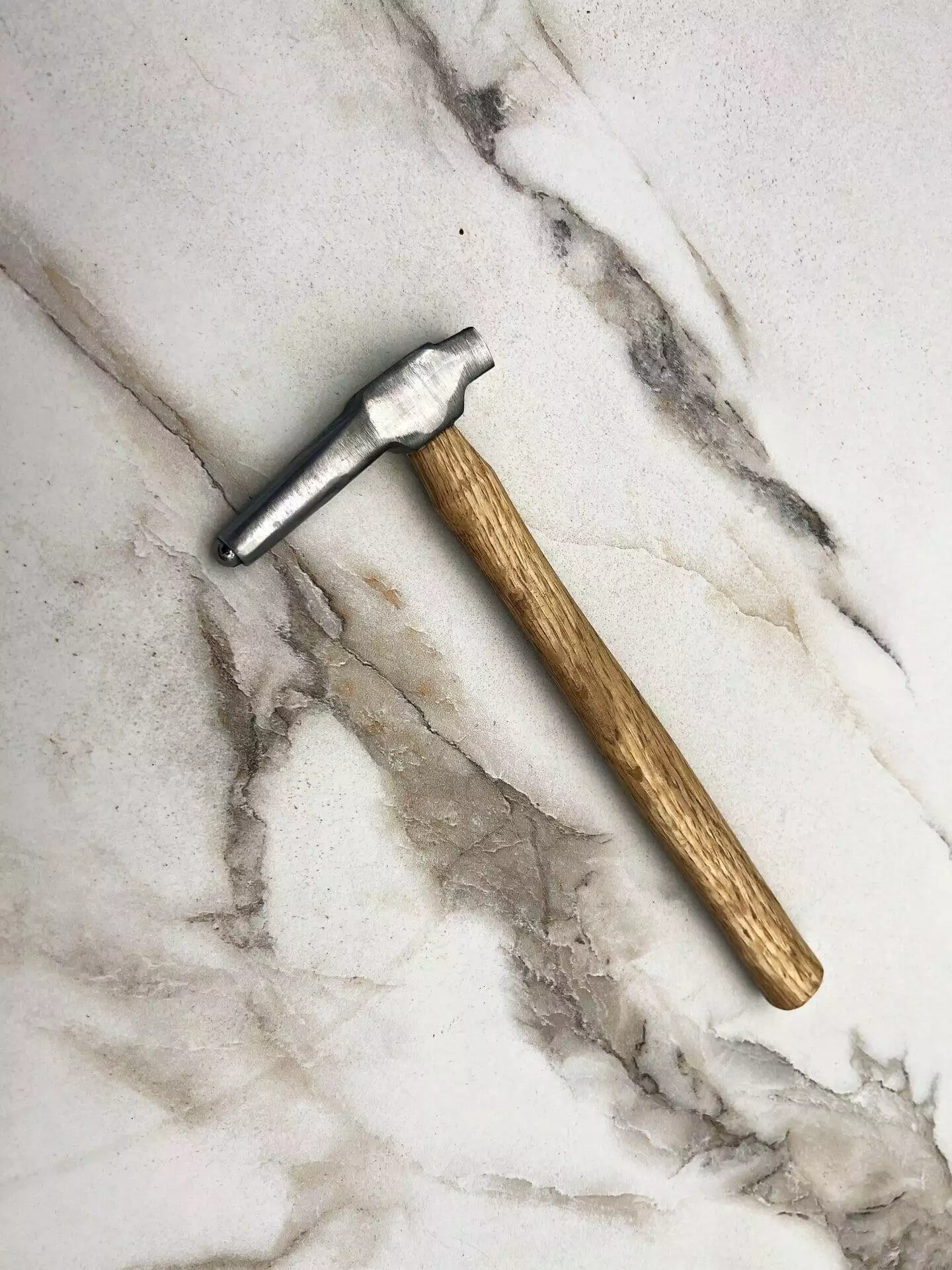 Carbide Tipped Straightening Hammer, marble surface.