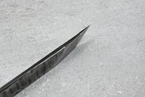 A knife from the Halloween Special! - 3 Piece Full Set is sitting on top of a concrete surface.