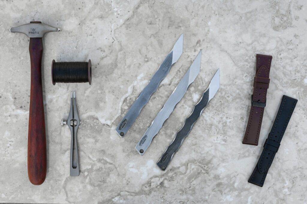 A set of hammer tools and a stone surface.