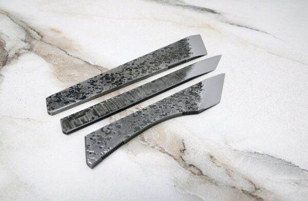 Three knives on a marble surface, featuring the FRIDAY THE 13th - Triple Blade Special.