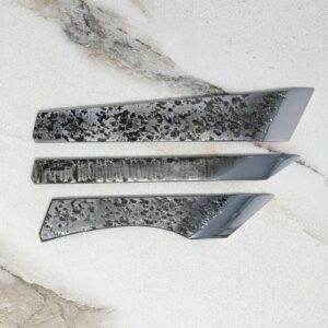 A set of FRIDAY THE 13th - Triple Blade Special knives on a marble surface.