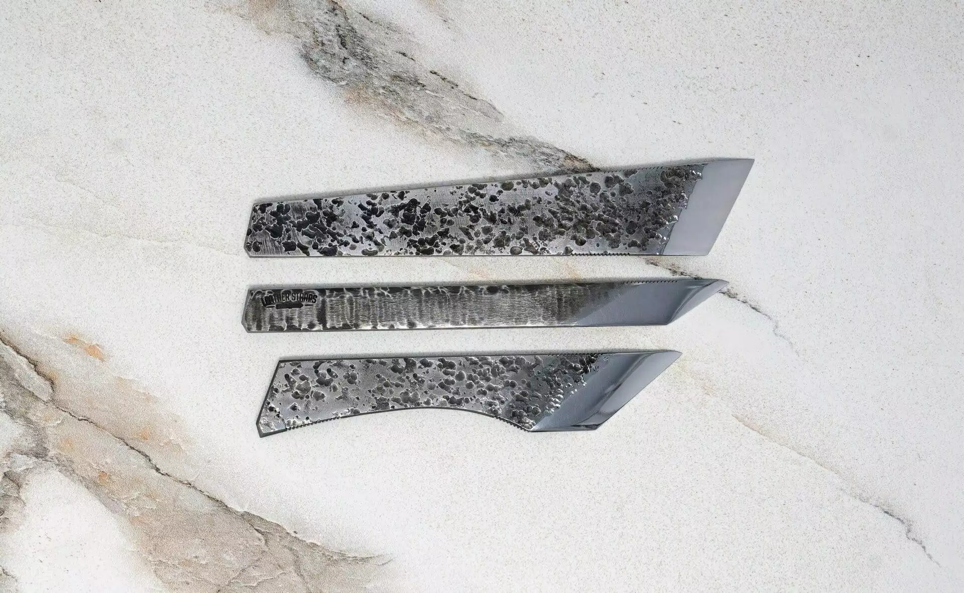 A set of FRIDAY THE 13th - Triple Blade Special knives on a marble surface.