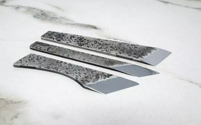 A FRIDAY THE 13th - Triple Blade Special featuring a set of knives on a marble surface.