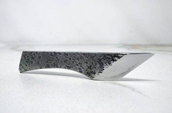 A FRIDAY THE 13th - Triple Blade Special with a black handle on a white surface.