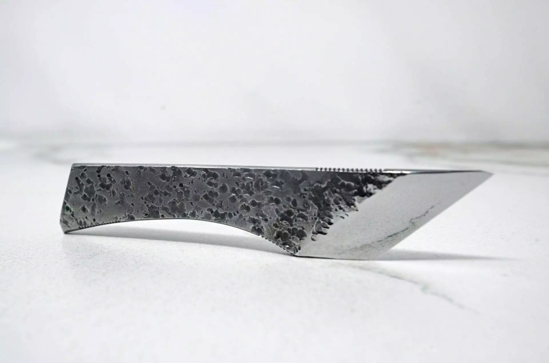 A FRIDAY THE 13th - Triple Blade Special with a black handle on a white surface.