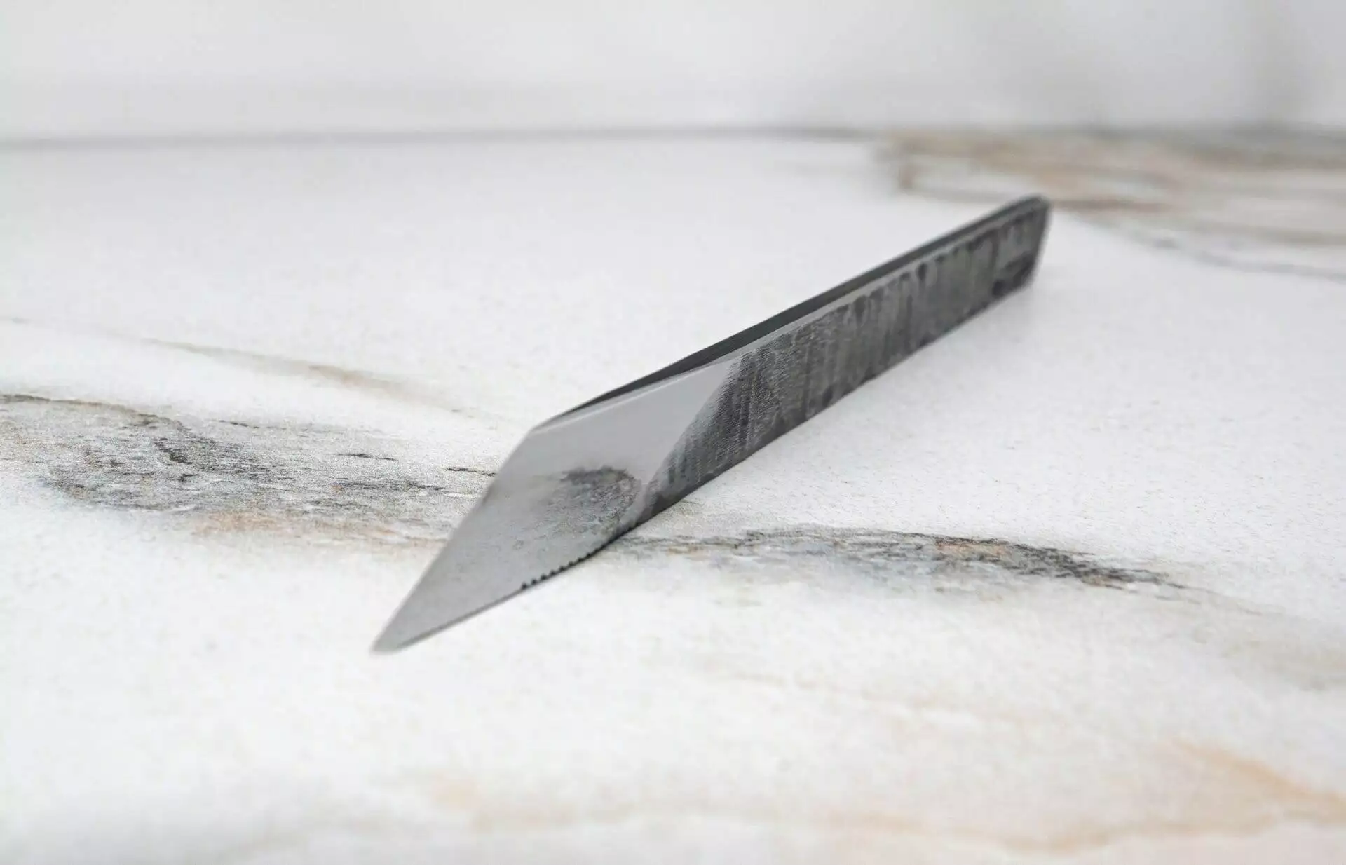 FRIDAY THE 13th - Triple Blade Special is sitting on top of a marble surface.