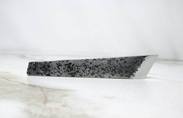 A knife with black and white speckles on it in the FRIDAY THE 13th - Triple Blade Special edition.