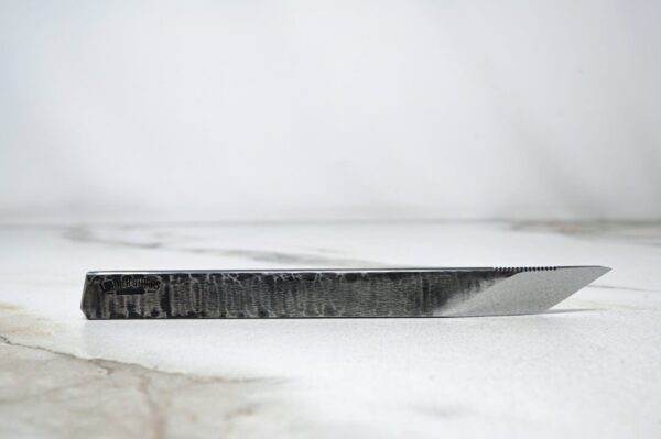 The RipTide Scalpel is sitting on top of a marble surface.