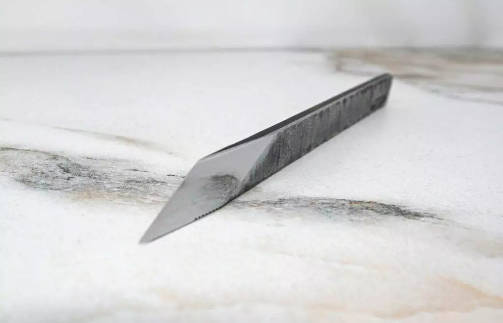 The RipTide Scalpel is sitting on top of a marble surface.