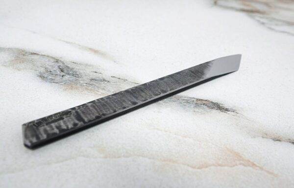 A black The RipTide Scalpel on top of a marble surface.