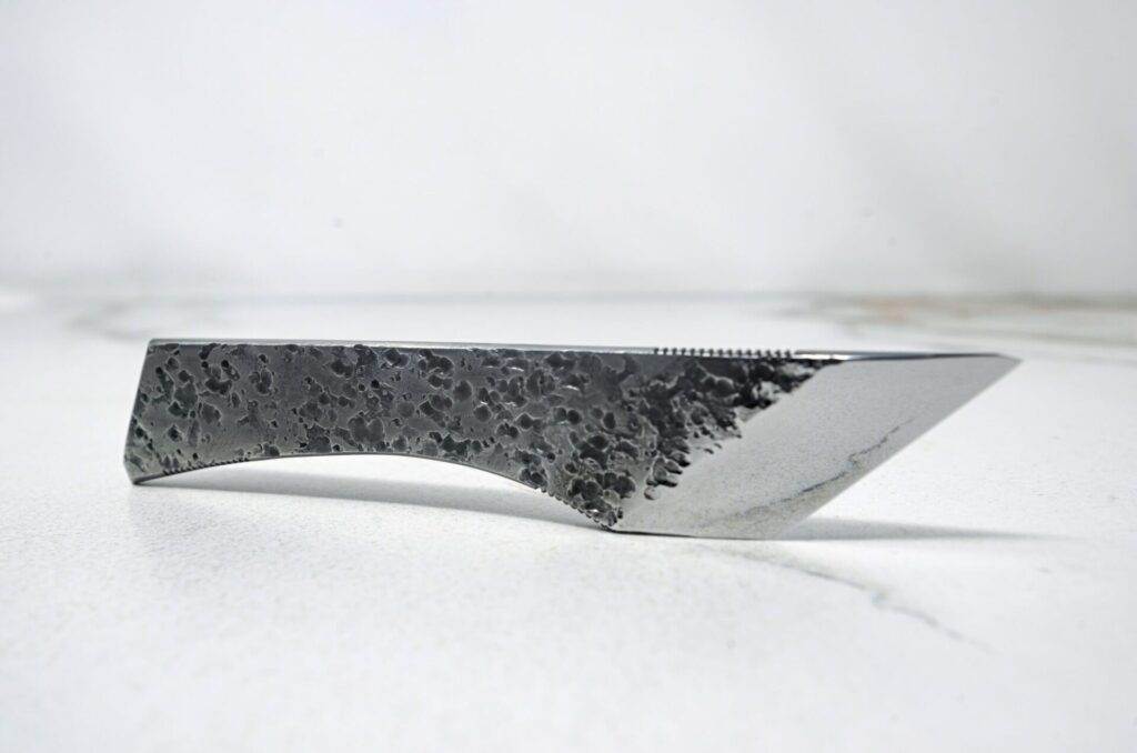 The Scorpion Skiver (45 Degree Bevel), black handle, white surface.