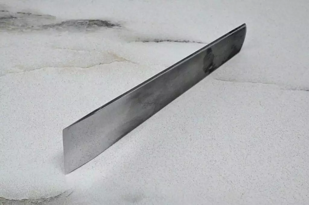 A 3 Leathercraft Knife Holiday Special with a stainless steel blade on top of a marble surface.