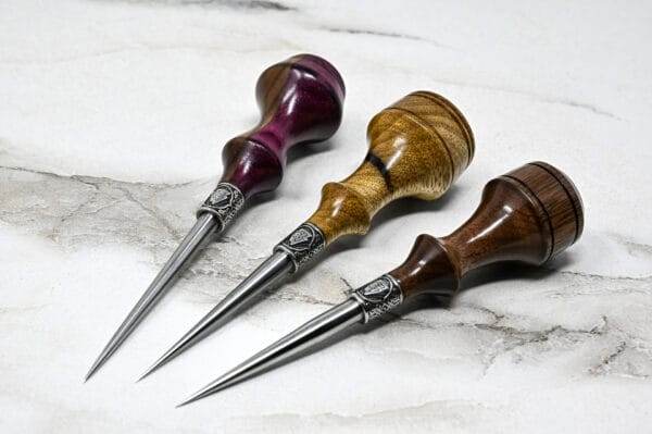 Three Leathercraft Knife Holiday Special delicately arranged on a smooth marble surface.