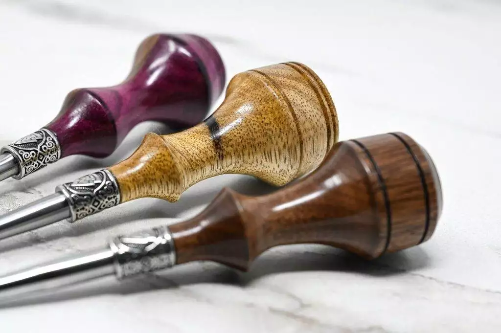 A 3 Leathercraft Knife Holiday Special display featuring a group of different colored wooden pipes on a marble table.