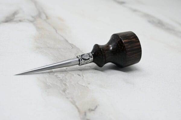 A small wooden spoon on a marble table, available for pre-release sale: Pre-release sale Japanese Leather Knife + Small Awl.