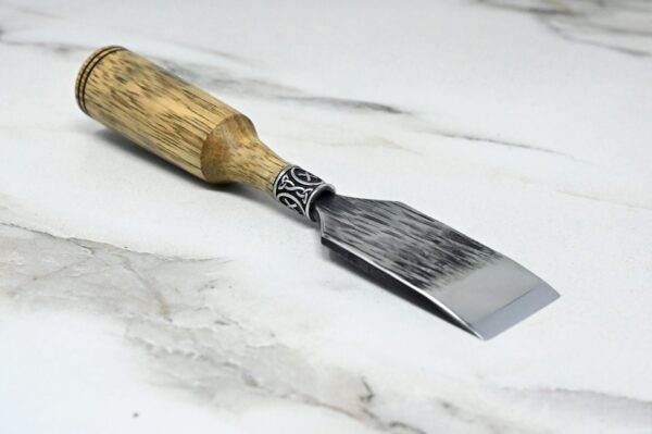 A Japanese Leather Knife on a marble surface.