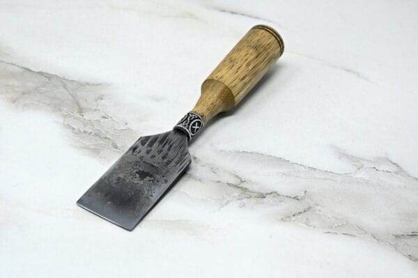 A Japanese Leather Knife on a marble surface.