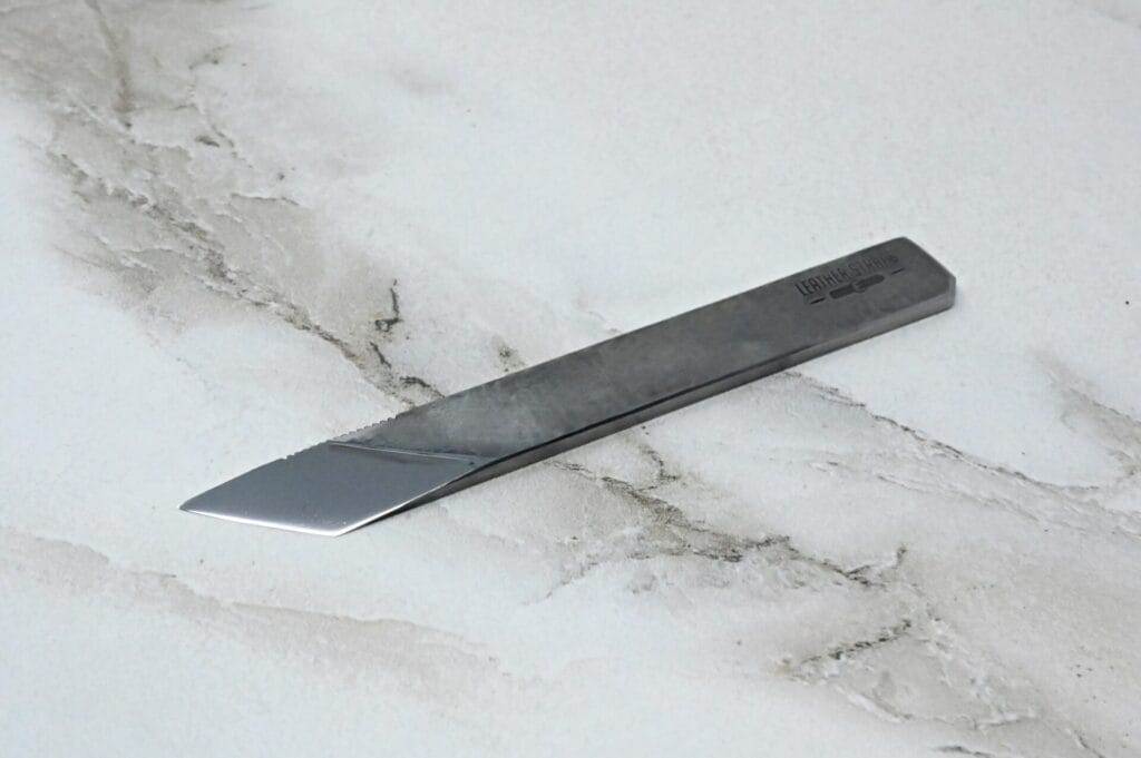 A small knife on a marble surface.