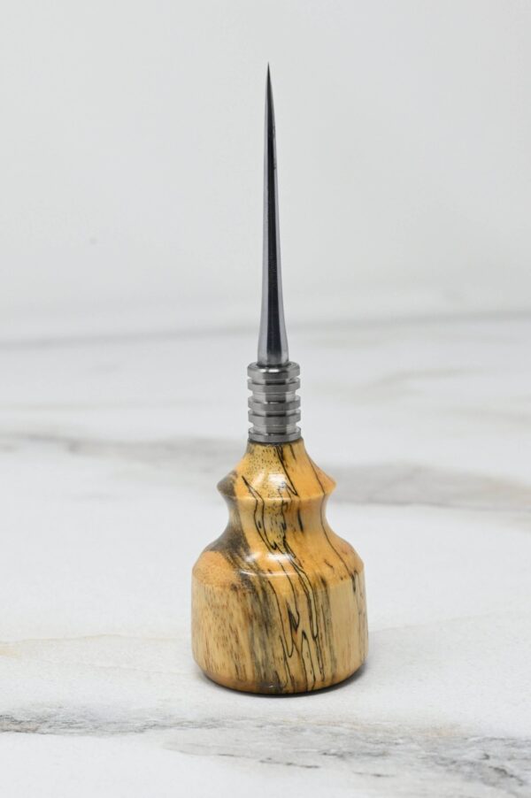 A tool with a sharp, pointed metal tip and a wooden handle is standing upright on a white surface: Small Leathercraft Scratch and Poking Awls.