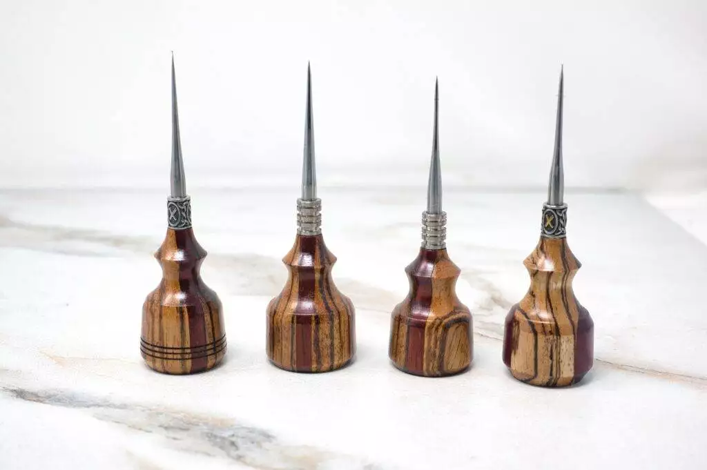 For 1 Day Only, make your project special with Steve's Birthday 4 Piece Special - 8 Sets Only! Displayed upright on a light marble surface, these four wood-handled metal awls with pointed tips are perfect for precision work. Join us in celebrating Steve's Birthday with these exclusive tools!