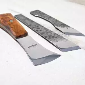 Displayed on a light surface, The Halloween 3 Piece Special showcases three knives with unique blade shapes and your choice of wood or metal handles, making it an elegant addition to your Halloween preparations.