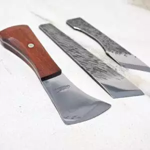 The Halloween 3 Piece Special includes three woodworking knives, each with a unique blade shape and wooden handles, attractively arranged on a light surface, ideal for creating Halloween decorations.