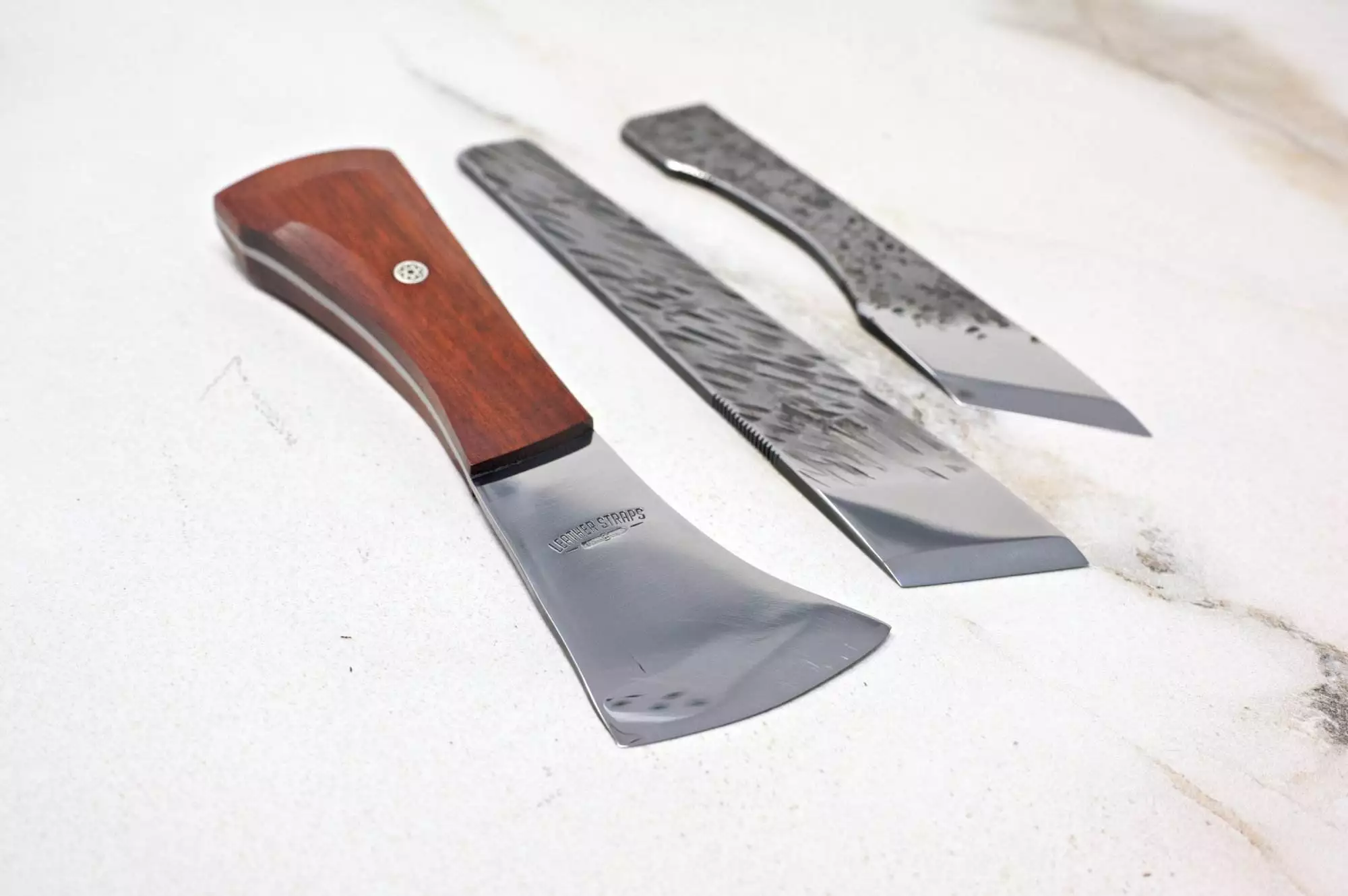 The Halloween 3 Piece Special includes three woodworking knives, each with a unique blade shape and wooden handles, attractively arranged on a light surface, ideal for creating Halloween decorations.