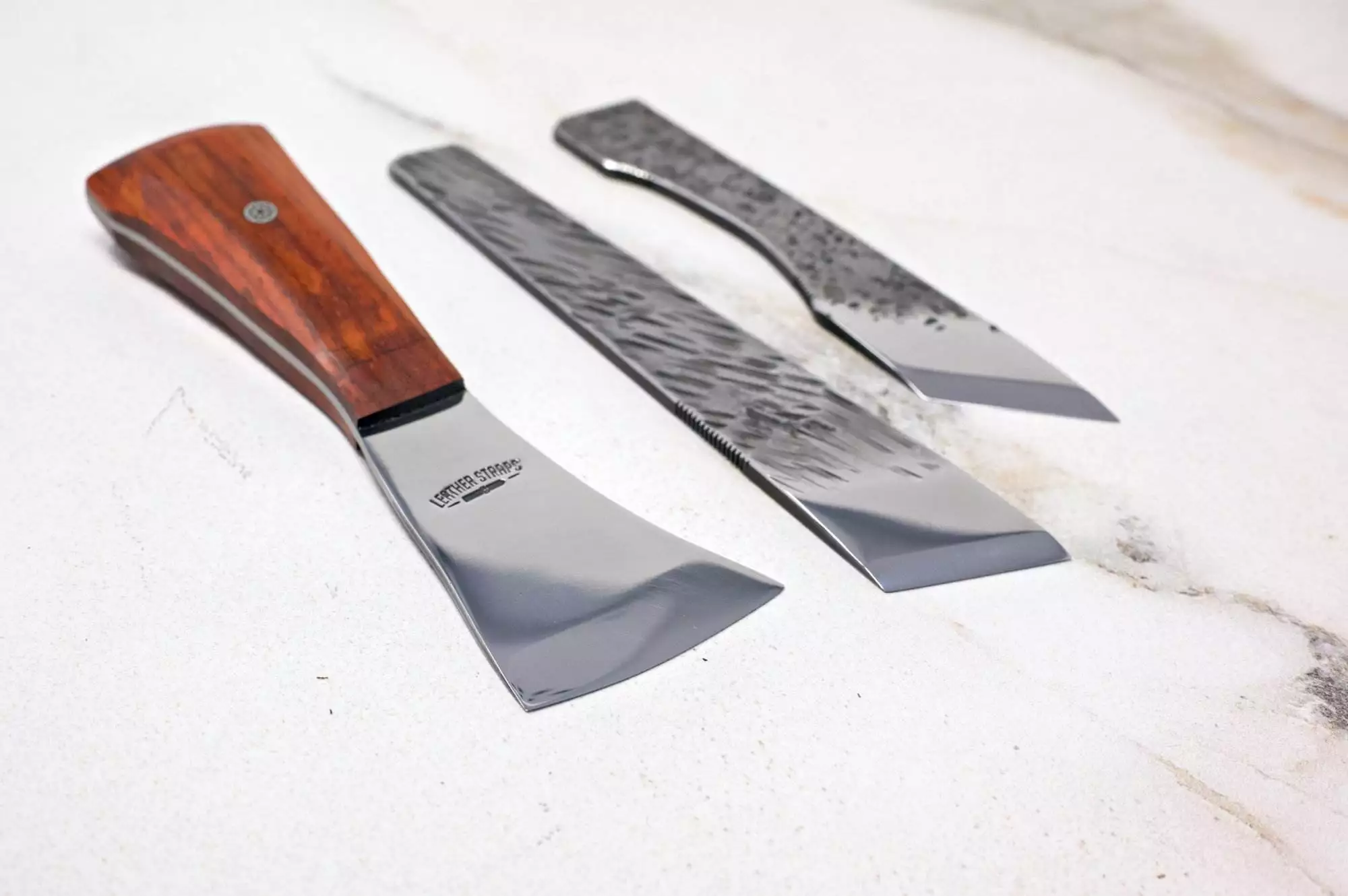 Displayed on a white surface, The Halloween 3 Piece Special includes three Japanese kiridashi knives with steel blades and unique handles, ideal for enhancing your Halloween display with an authentic touch.