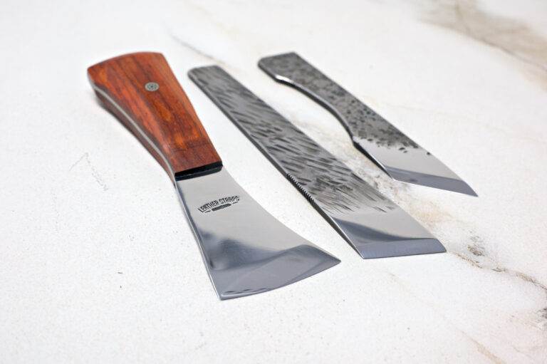 The Halloween 3 Piece Special, featuring three polished metal woodworking chisels in different sizes from Japan, is skillfully showcased on a light surface, making it a must-have for any craftsperson this Halloween.