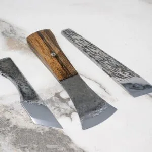 The March Madness 3 Piece Essentials set features knives with textured blades and wooden handles, elegantly displayed on a marble surface.